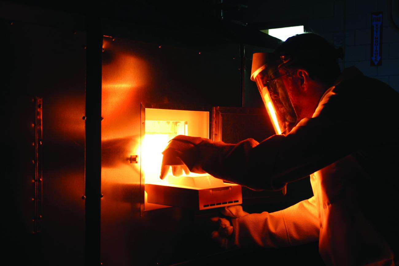 Ames Laboratory scientist Paul Canfield removes a sample from a flux-growth furnace.