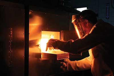 Researcher Paul Canfield removing a sample from a flux-growth furnace